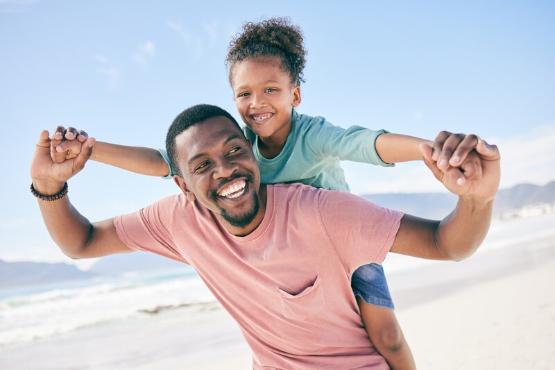 teacher on vacation with his child at the beach